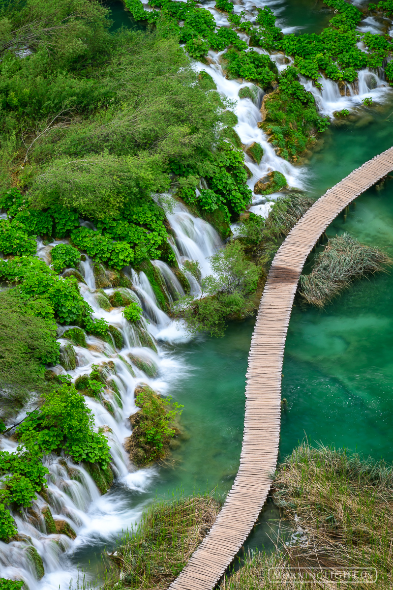 A boardwalk winds its way past waterfalls in Plitvice National Park, Croatia.