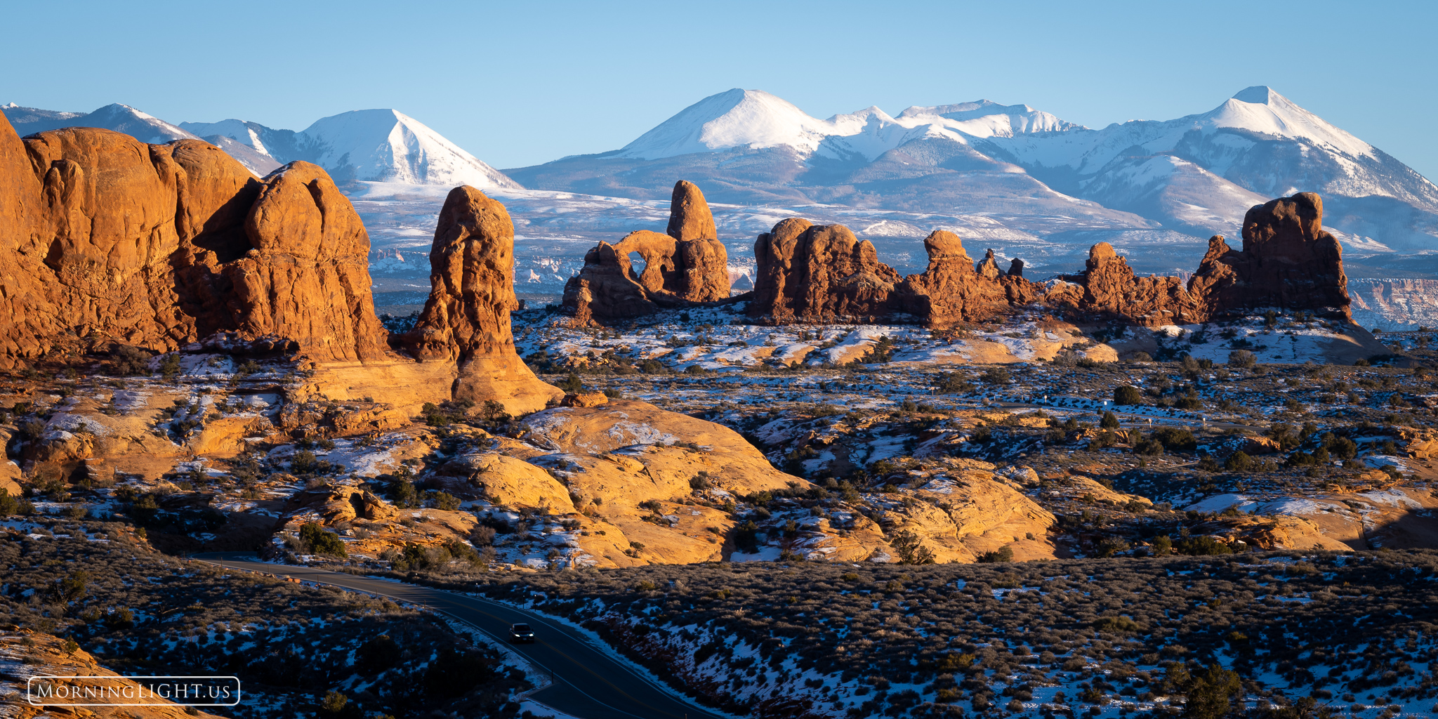 A chilly winter sunset in Arches National Park with the La Sal Mountains in the background.