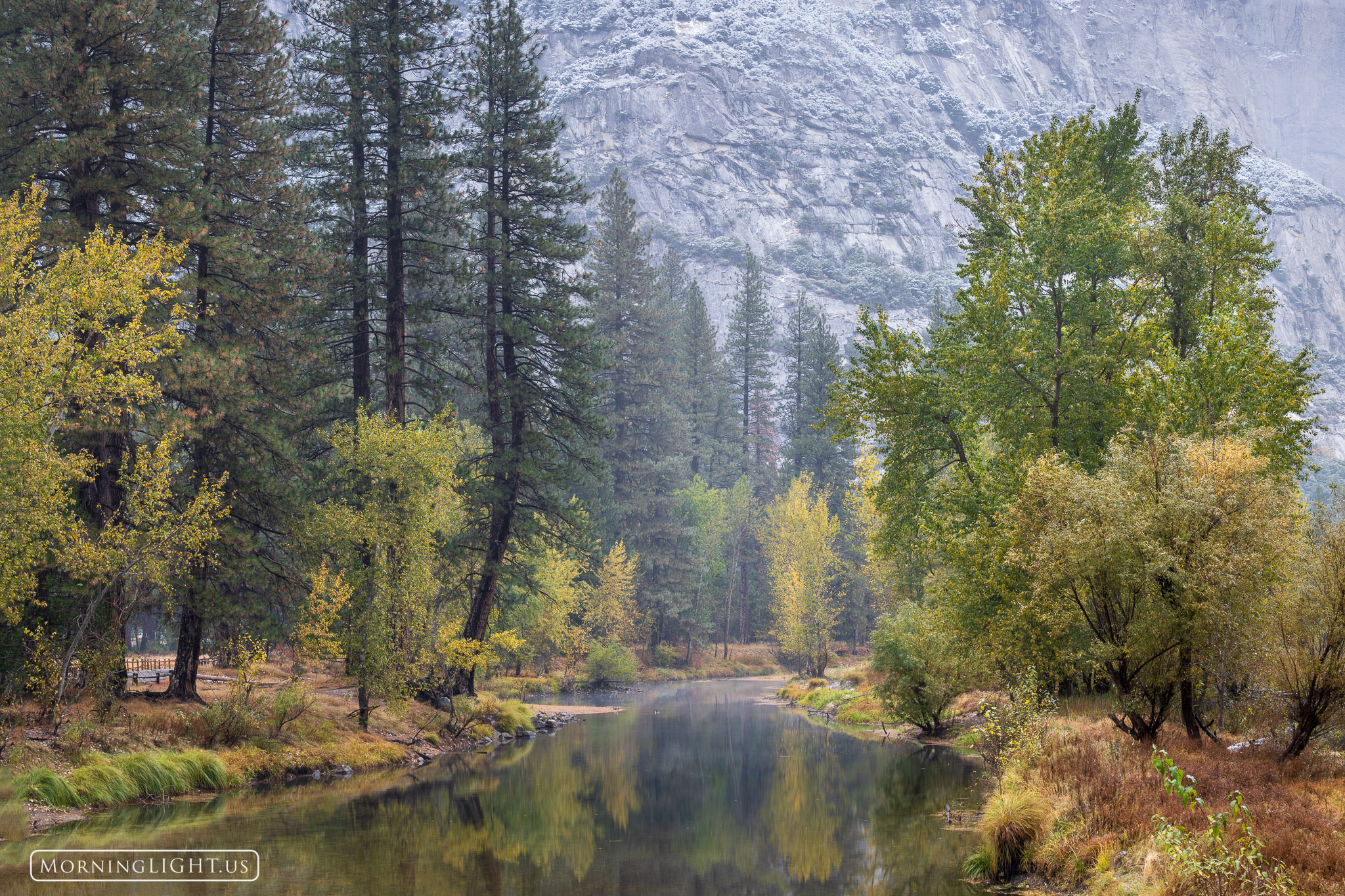 On a quiet autumn morning, the Merced River made its way through through the middle of Yosemite Valley in a world tinted with...
