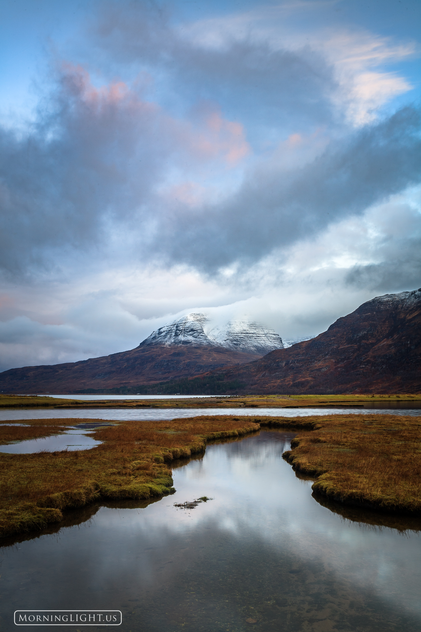 A fast moving storm over Upper Loch Torridon in the Scottish highlands with the imposing Beinn Allgin peak in the distance.