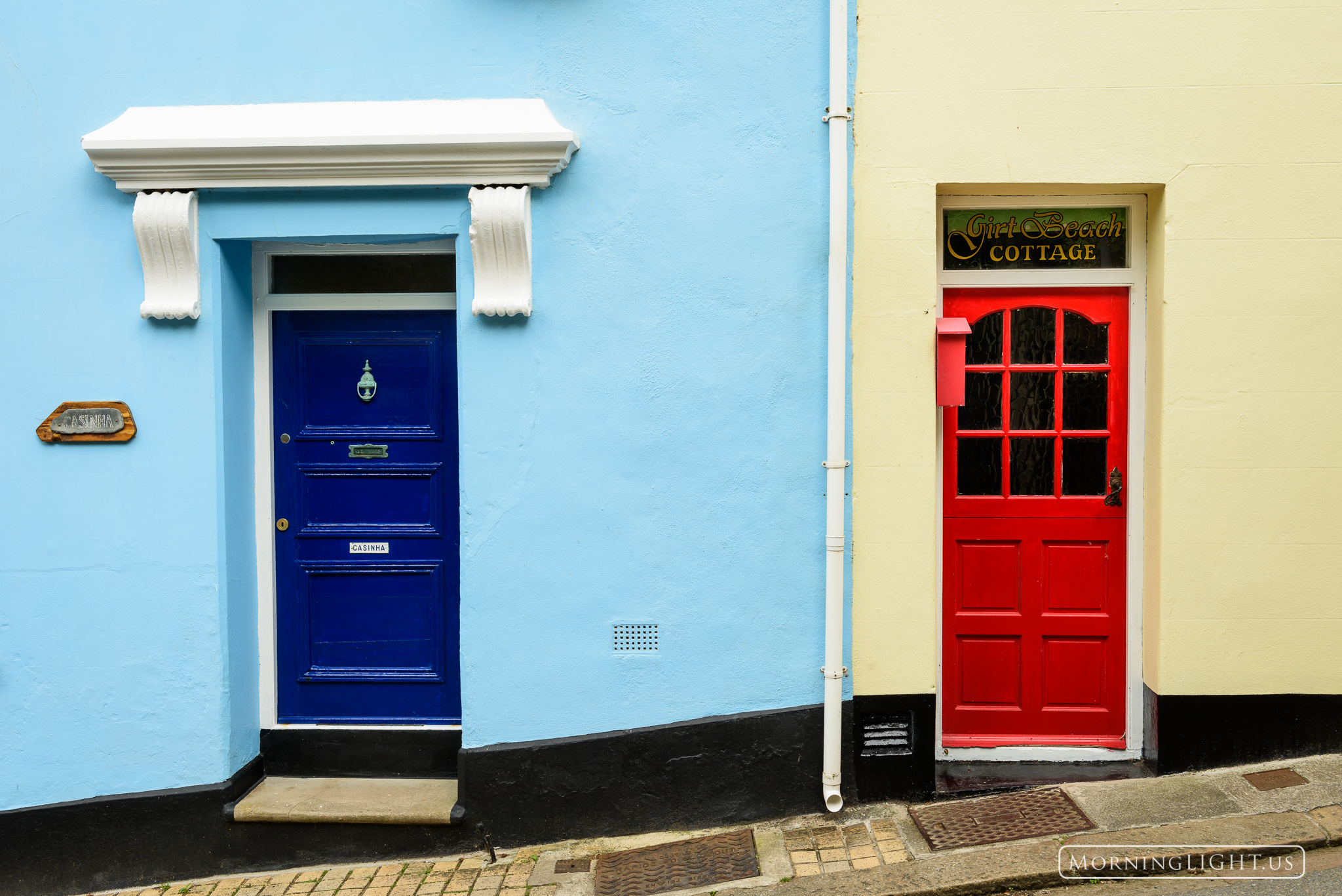 Two of the many colorful doors to be found in Kingsand, Cornwall, United Kingdom.