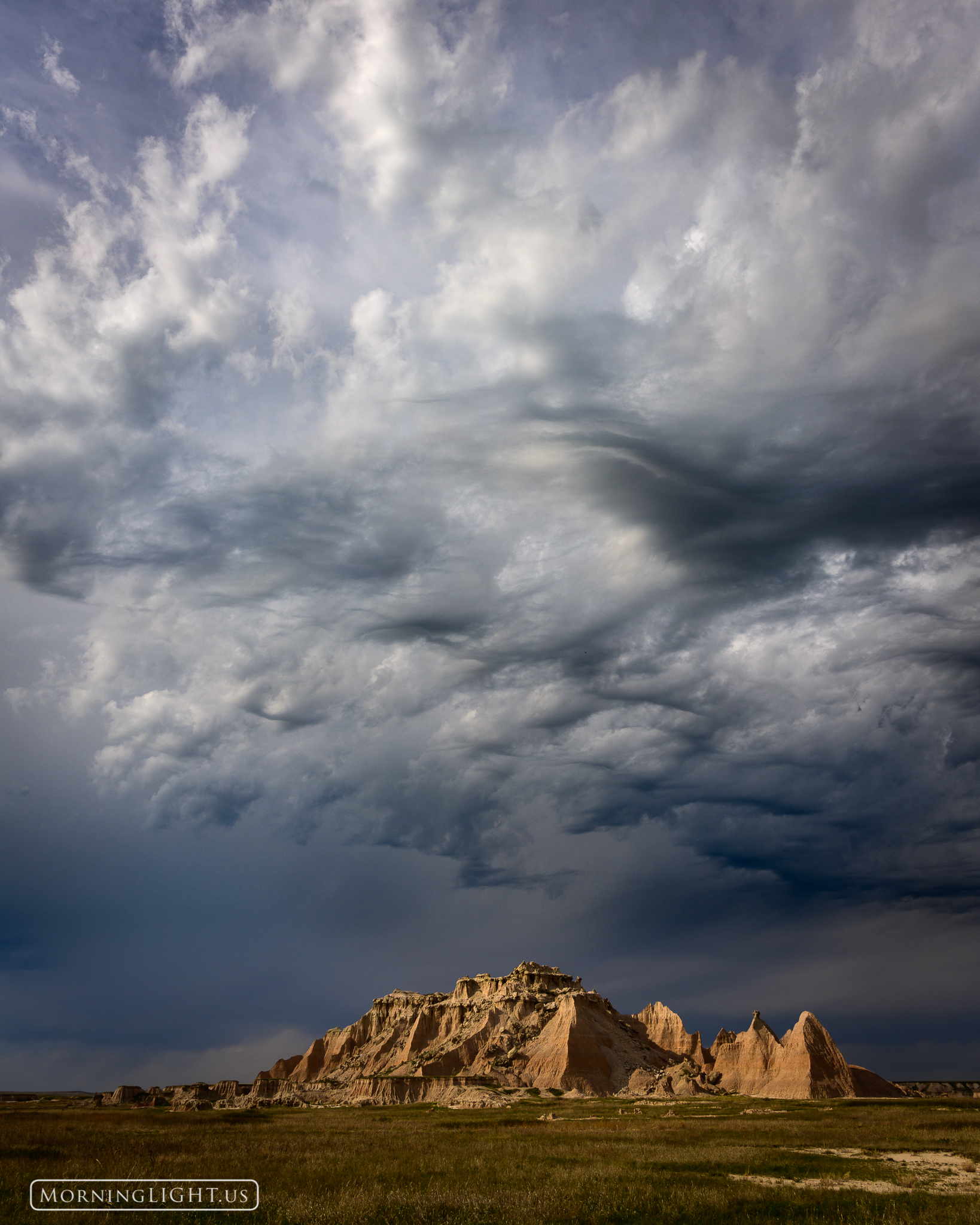 A thunderstorm builds over the South Dakota Badlands promising a deluge of rain on this rugged land.