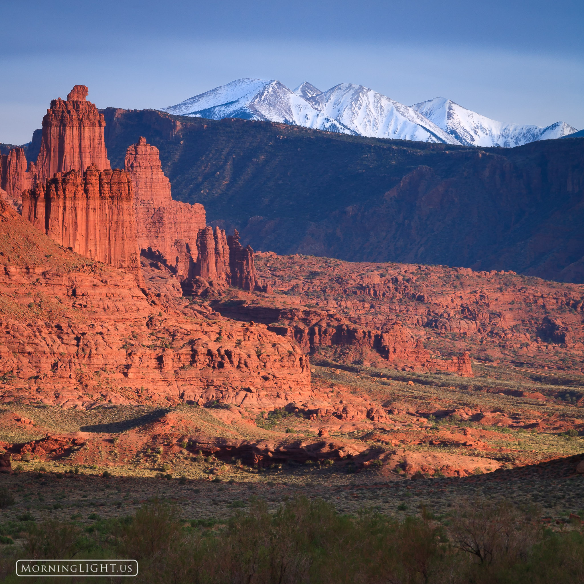 A view of Fisher Towers and the La Sal Mountains from north of Moab, Utah at sunset. This can be printed in sizes up to 24"x24...