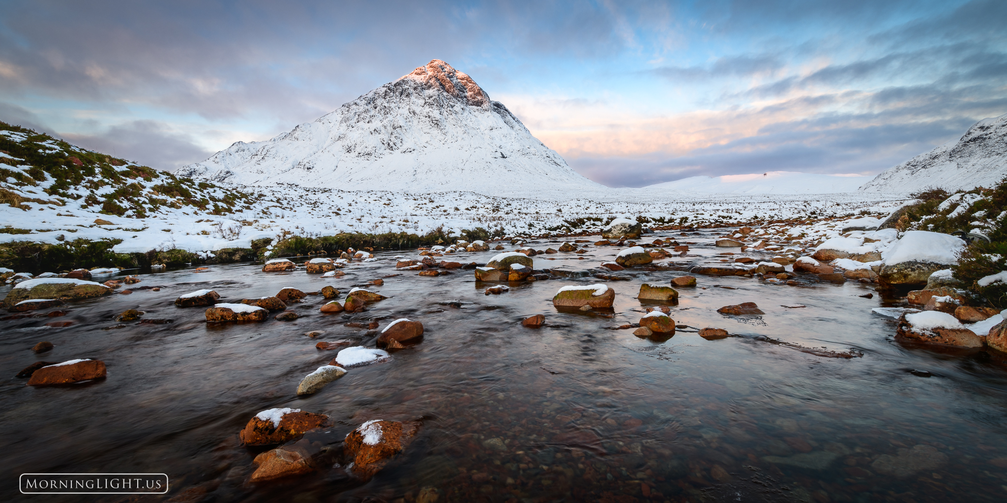 The morning light awakens the summit of Buachaille Etive Mòr after a fresh snow fall.