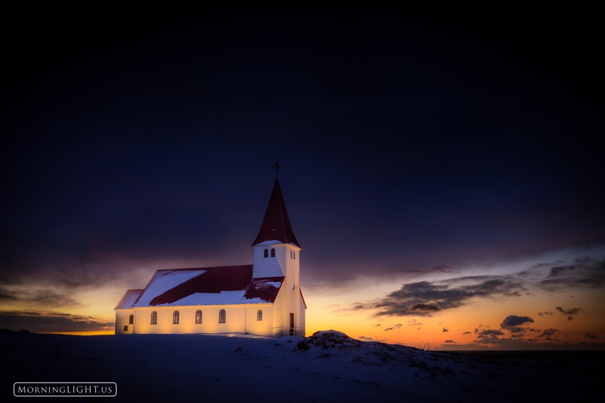The little church in Vik, Iceland high up on the hill over town glows at sunrise (which occurred at almost noon on this cold...