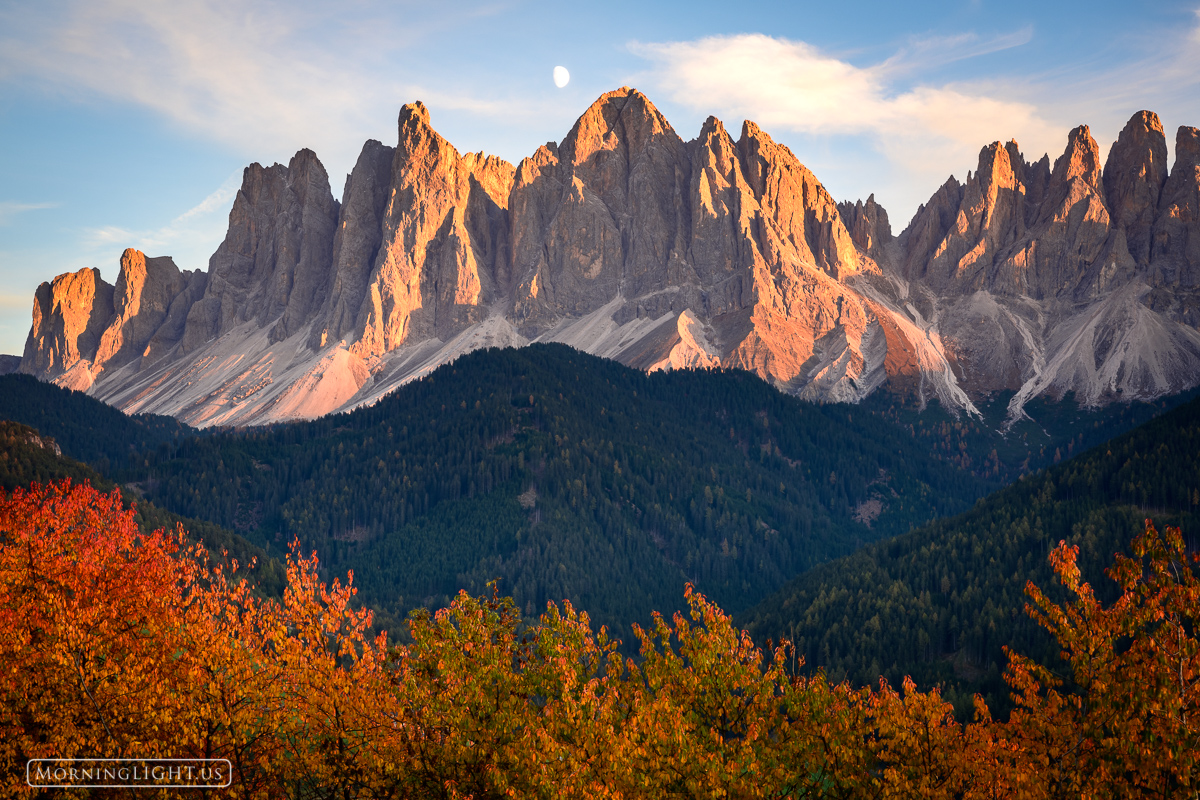 The moon set behind the jagged spires of the Dolomites in northern Italy on a spectacular autumn evening. It was the perfect...