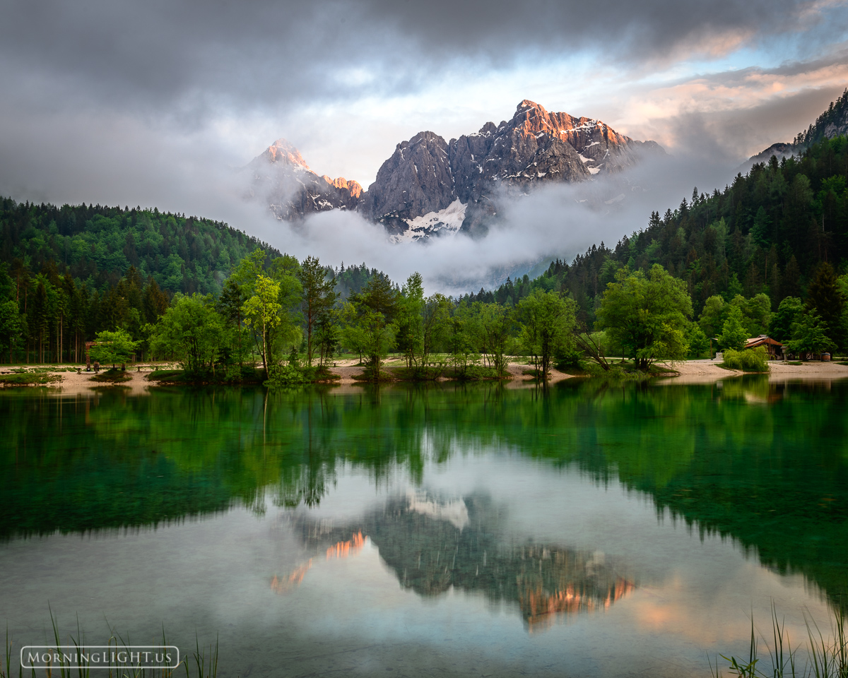 A breaking storm at Lake Jasna reveals the stunning peaks that had been hiding from us.