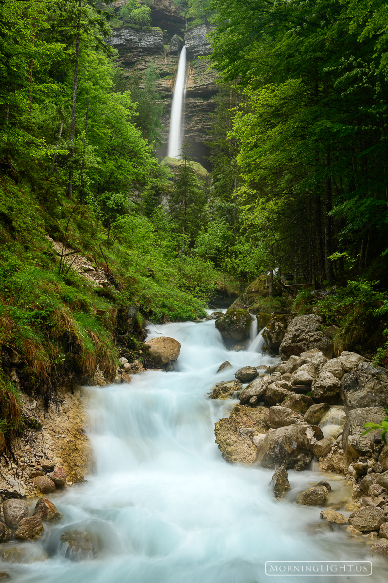 A large waterfall comes down from the Julian Alps on a May morning in Slovenia.