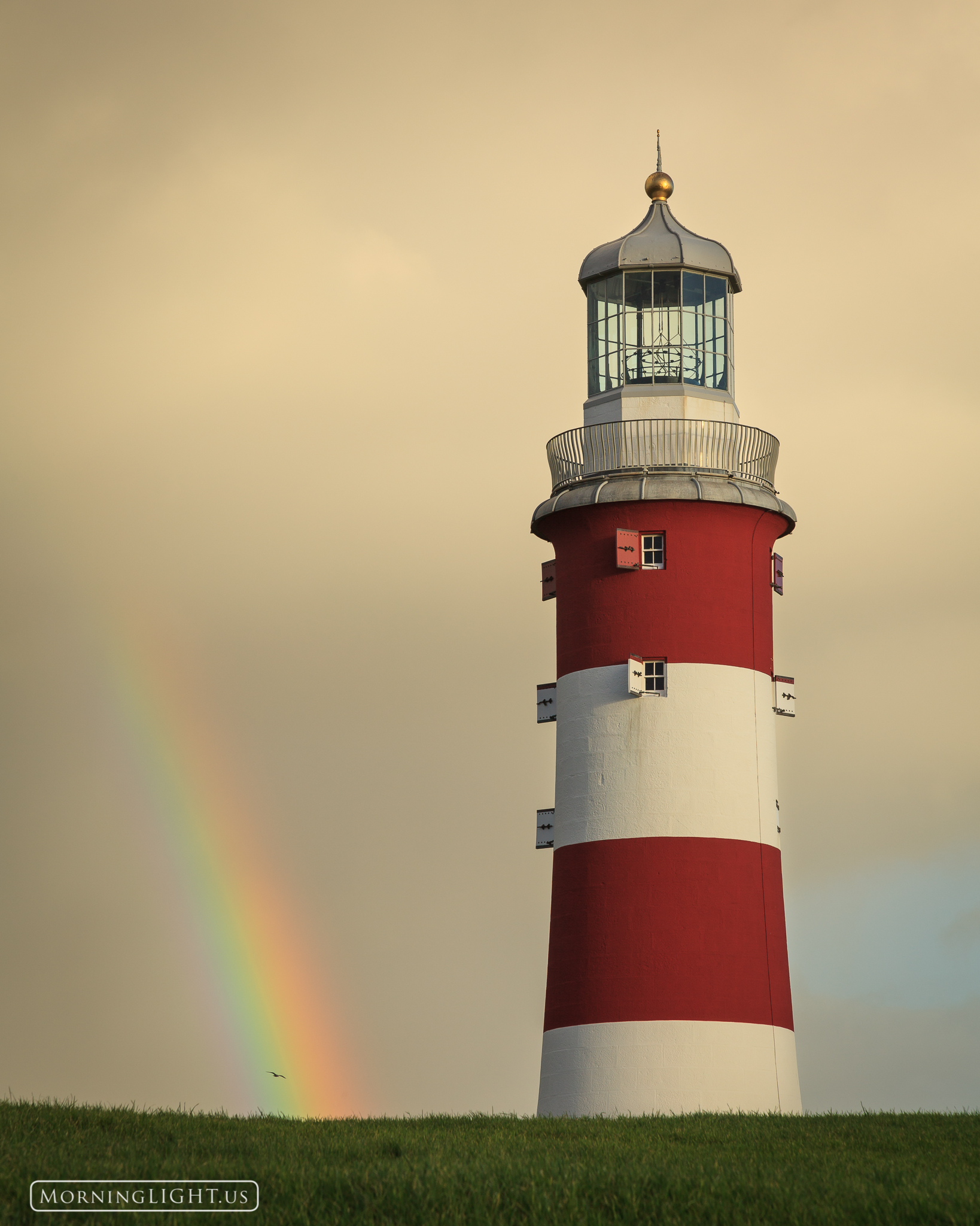 Following a rain storm the sun came out briefly creating a wonderful rainbow beside Smeaton's Tower, an old lighthouse along...