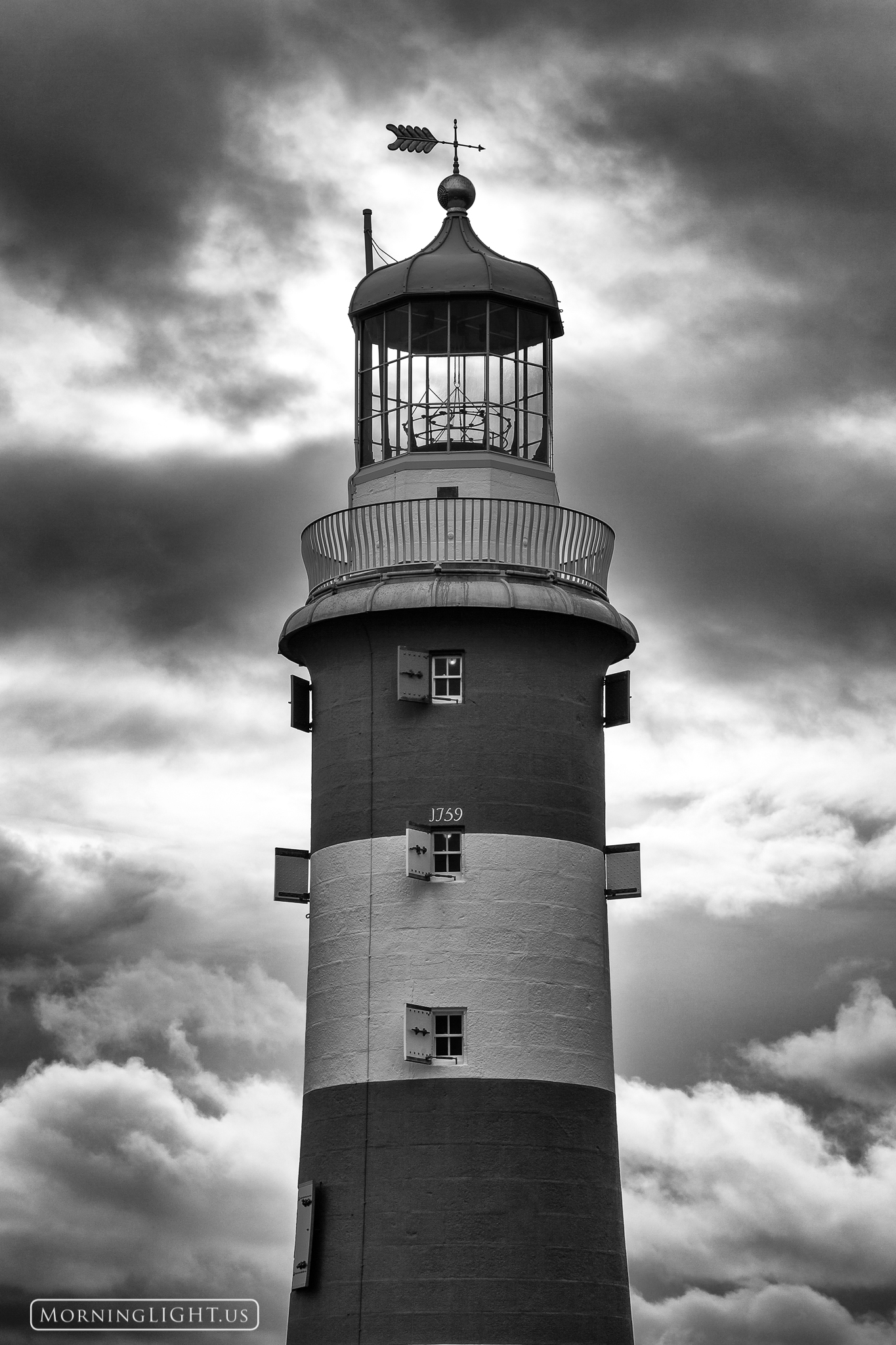 As as storm passes by Smeaton's Tower, a lighthouse in Plymouth England stands proudly, undaunted by the storm's threats.