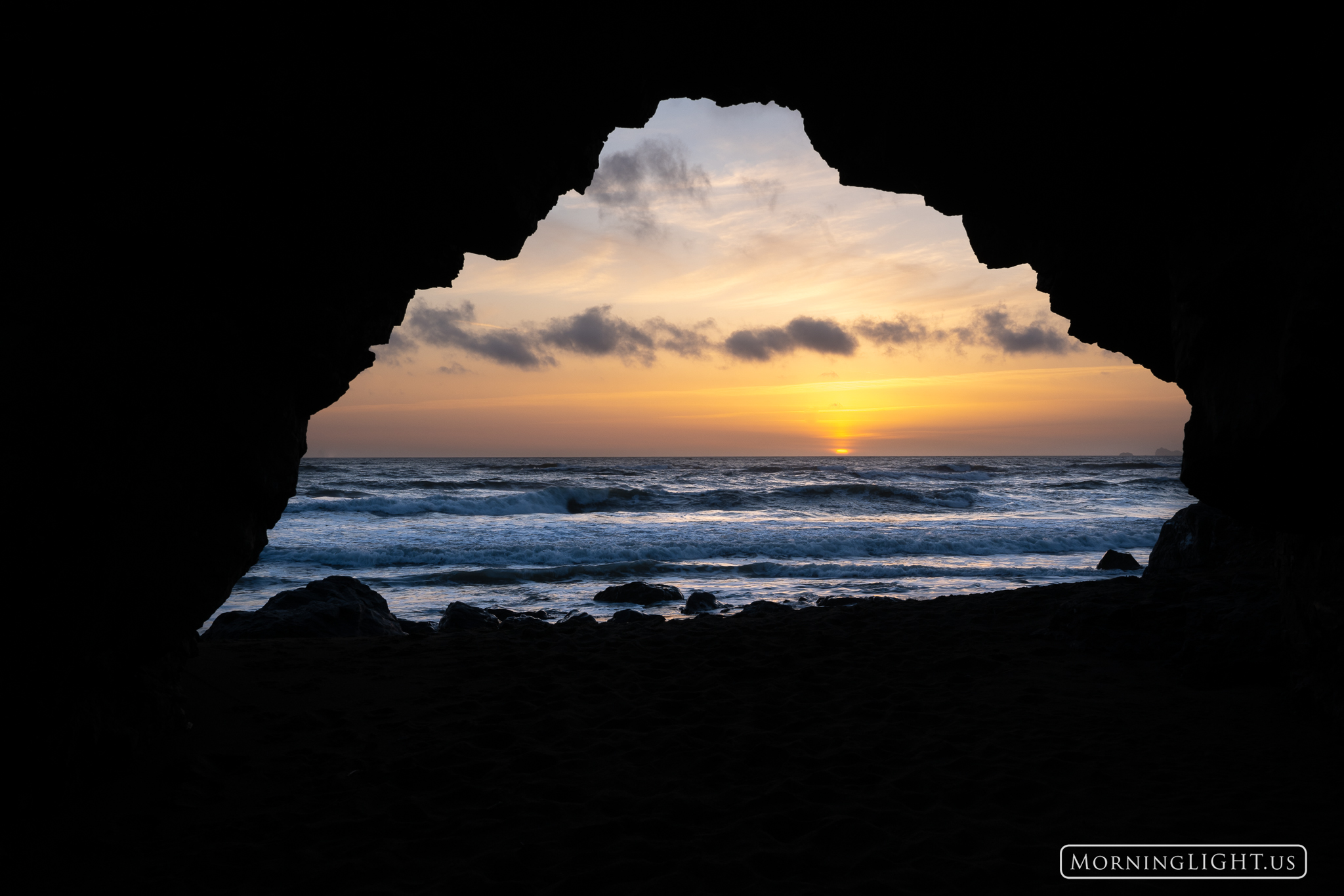 Sunset as seen from inside of a small arch along the Californa Coast.