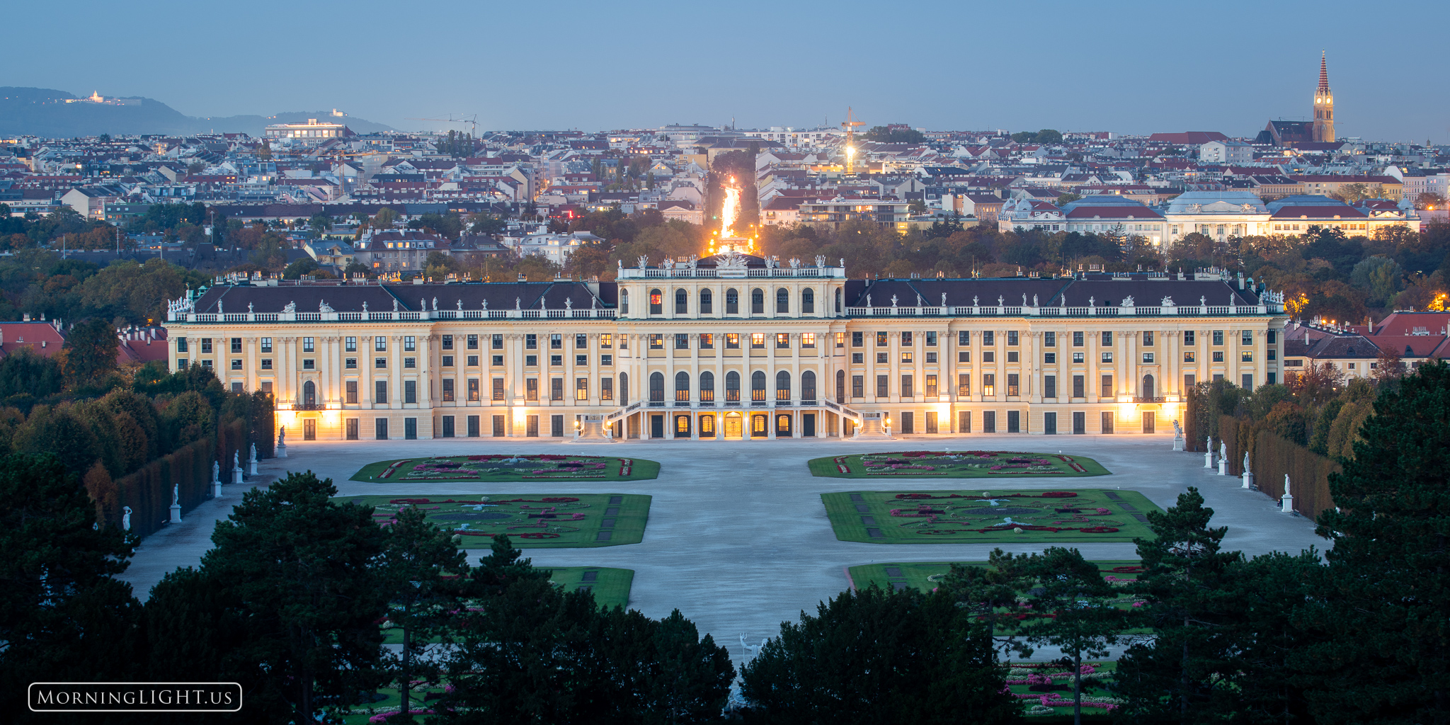 The Schoenbrunn Palace in Austria is all aglow as the sun sets on Vienna.