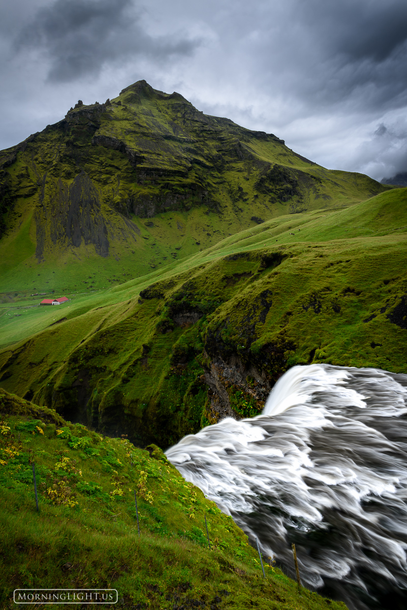 A storm moves in over the top of Skogafoss waterfall in southern Iceland.