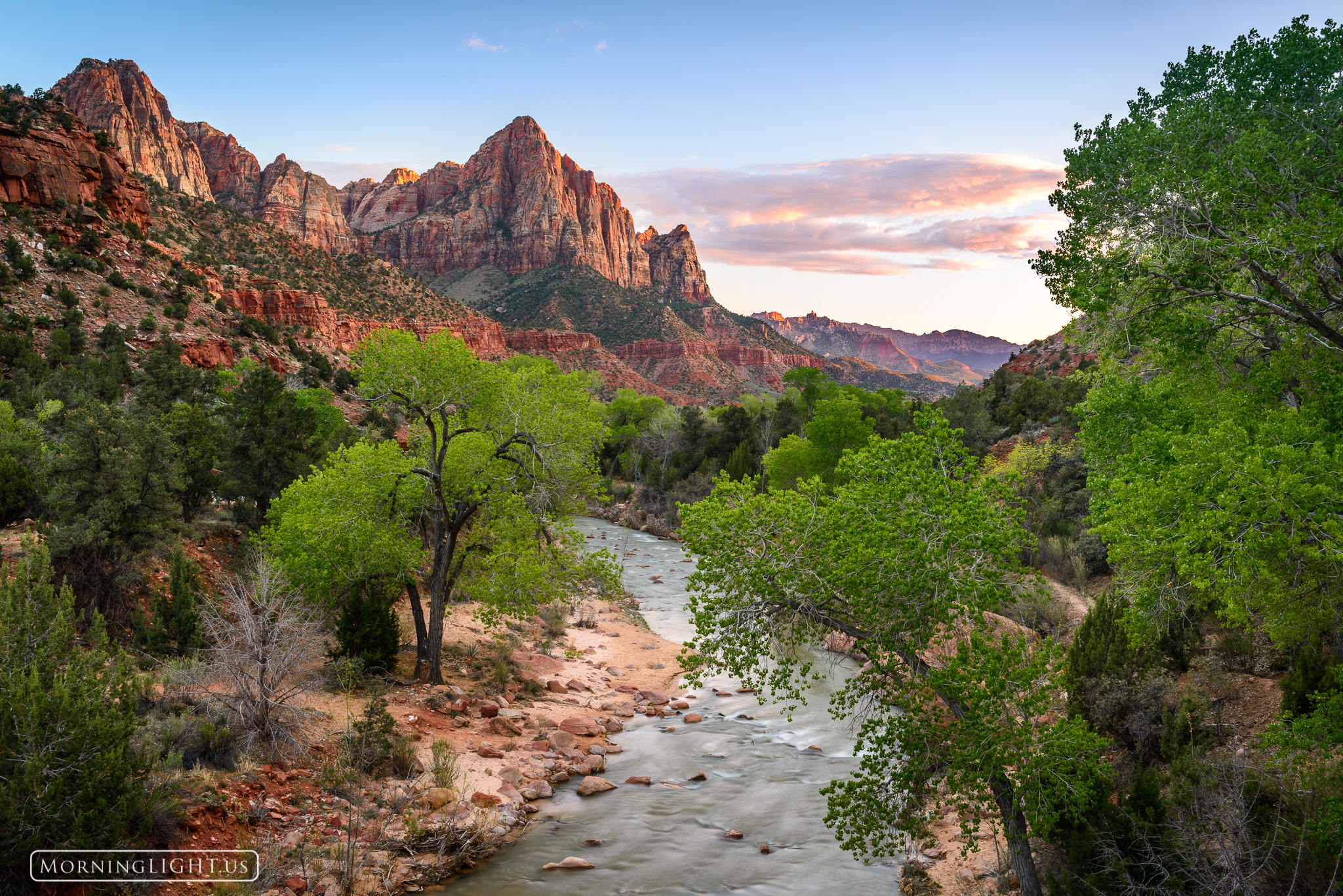 A beautiful spring sunset in Zion National Park. The mountain looking down over the Virgin River is known as the Watchman and...