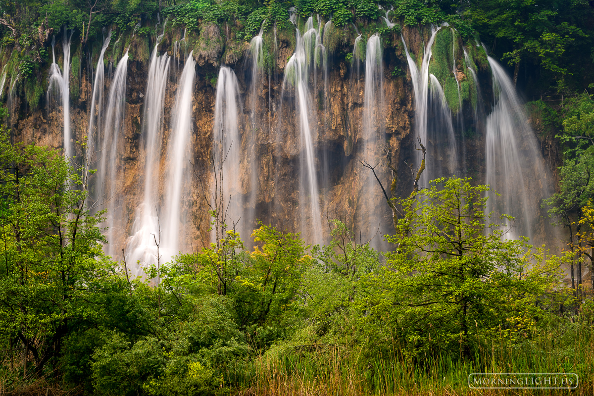 Magical waters fall in the forest of Plitvice Lakes National Park.